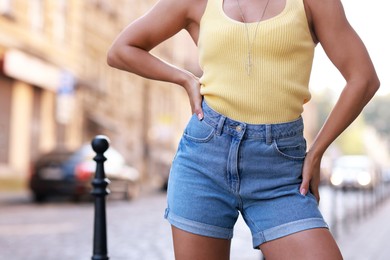 Woman wearing stylish denim shorts outdoors, closeup