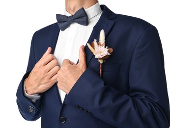 Photo of Groom in suit with stylish boutonniere on white background, closeup