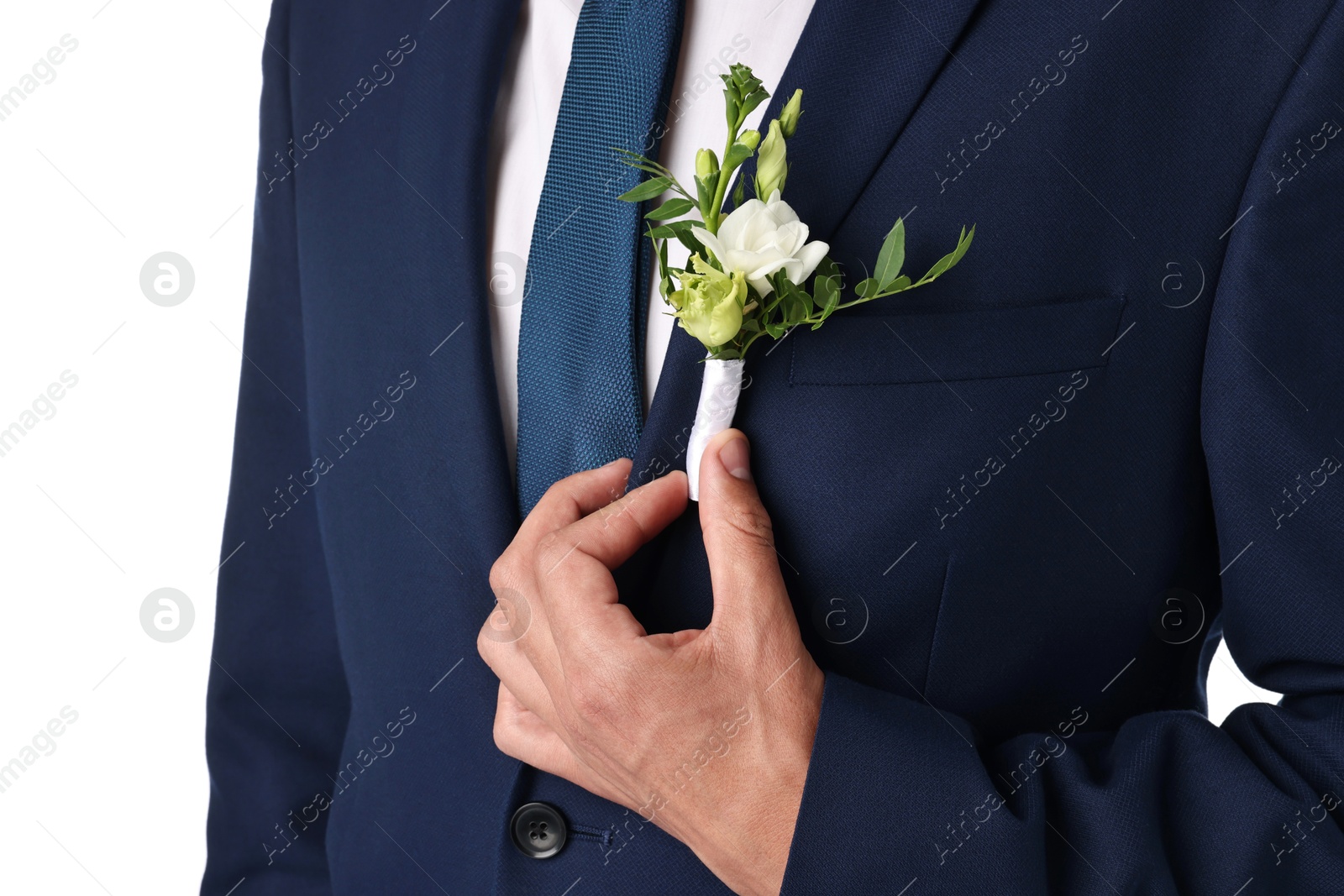 Photo of Groom in suit with stylish boutonniere on white background, closeup