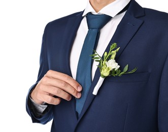 Photo of Groom in suit with stylish boutonniere on white background, closeup