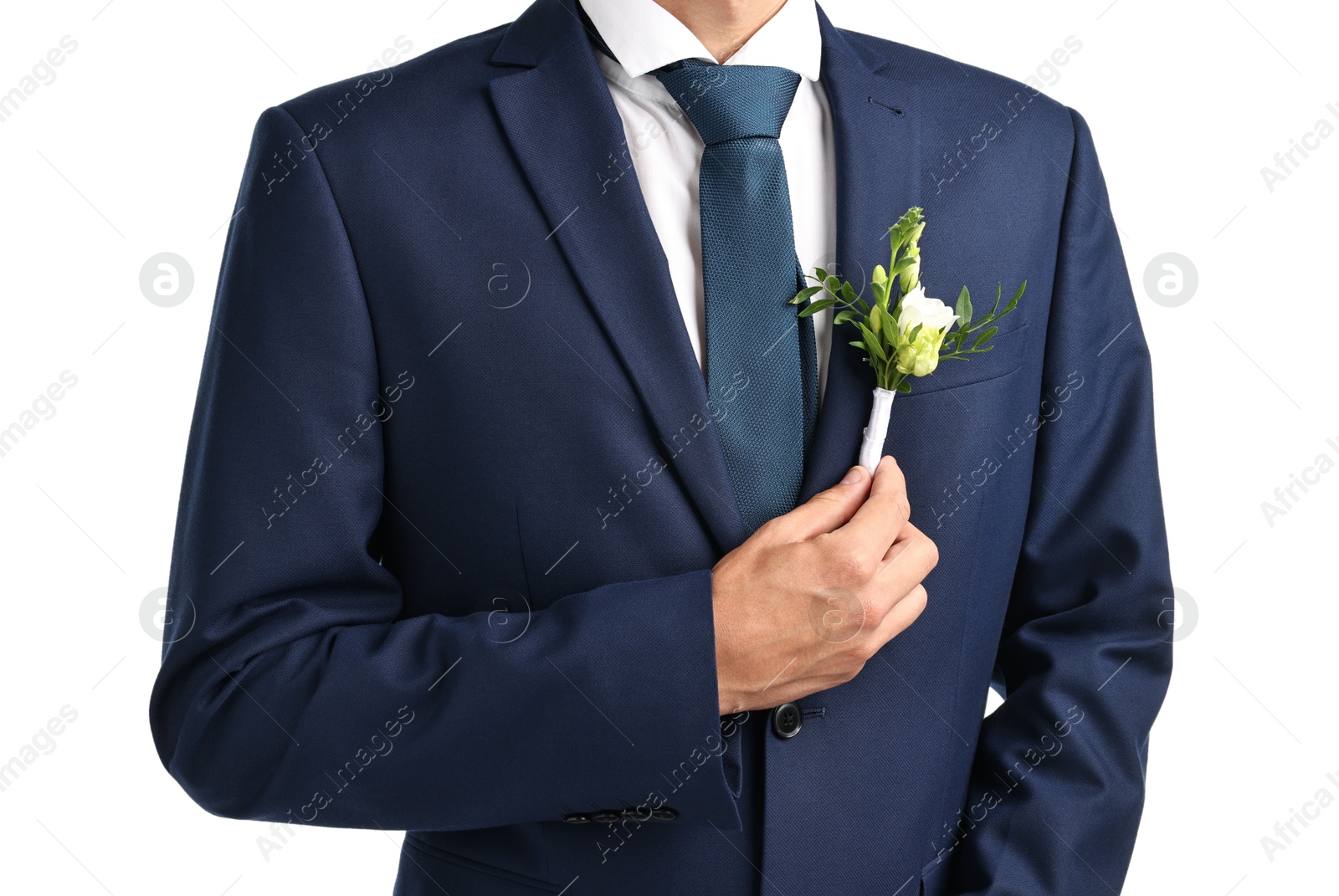 Photo of Groom in suit with stylish boutonniere on white background, closeup