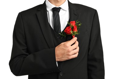 Photo of Groom in suit with stylish boutonniere on white background, closeup