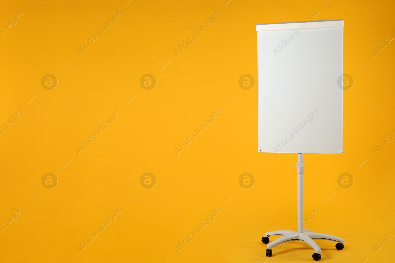 Photo of Flip chart on orange background. Mockup for design