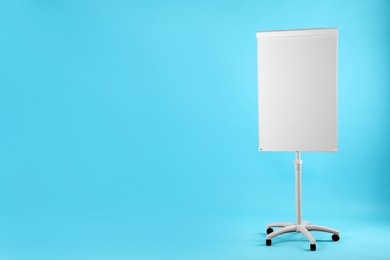 Photo of Flip chart on light blue background. Mockup for design