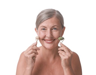 Photo of Beautiful woman doing facial massage with rollers on white background