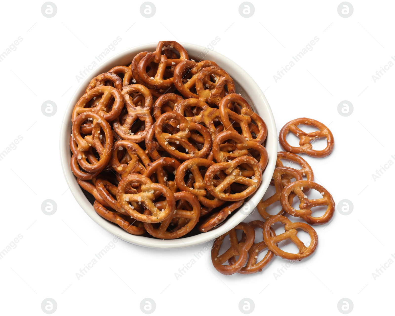 Photo of Delicious pretzel crackers in bowl isolated on white, top view