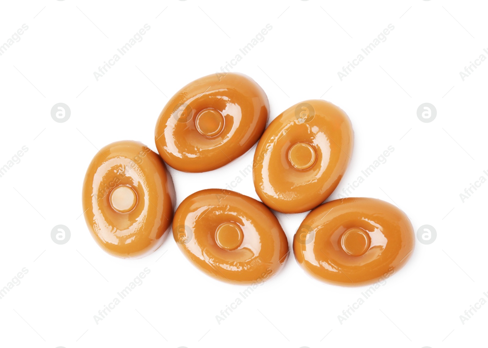 Photo of Tasty hard toffee candies isolated on white, top view