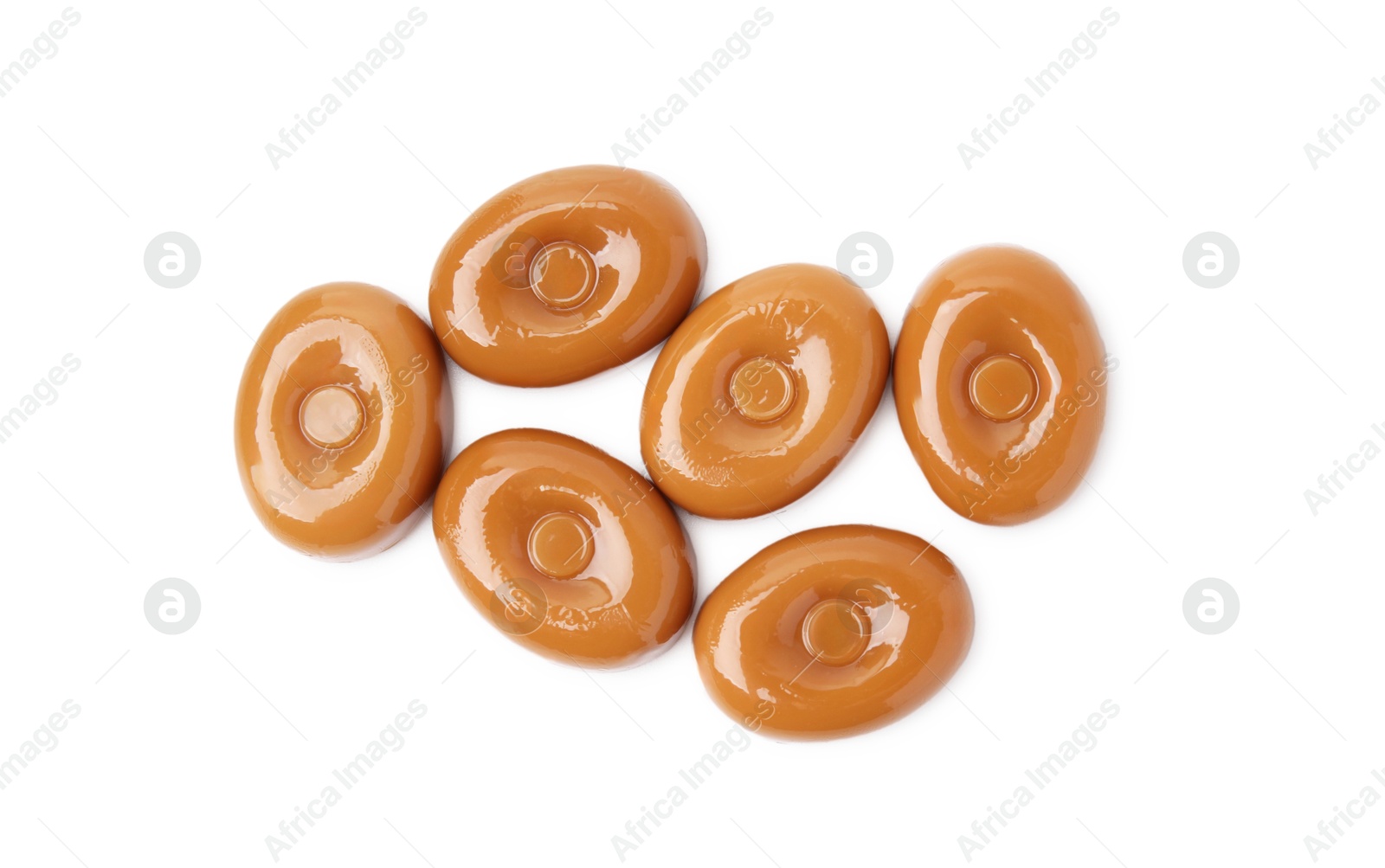 Photo of Tasty hard toffee candies isolated on white, top view