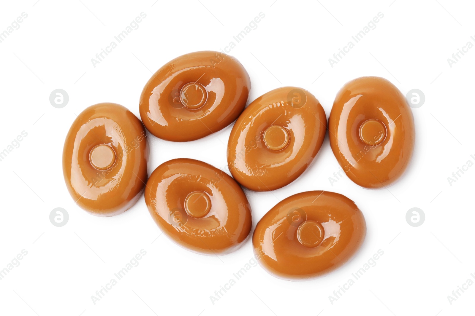 Photo of Tasty hard toffee candies isolated on white, top view