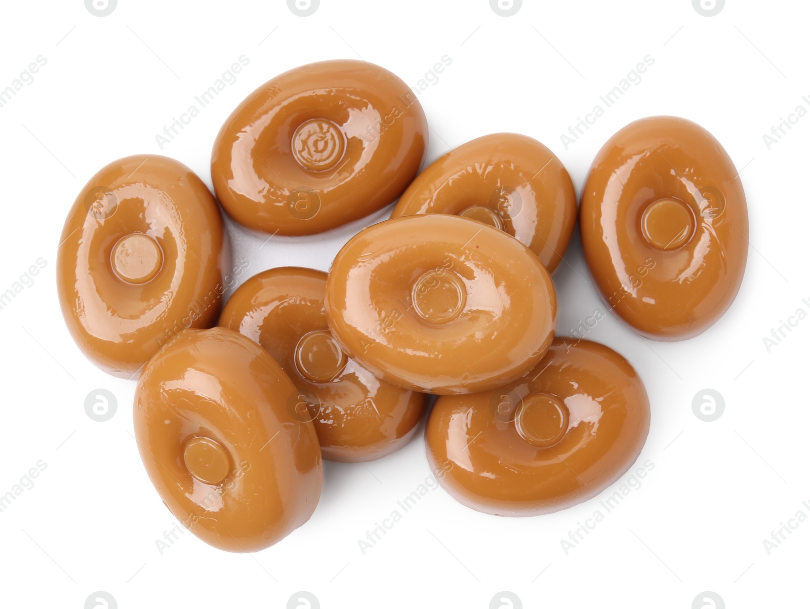 Photo of Tasty hard toffee candies isolated on white, top view