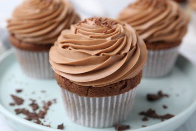 Photo of Tasty cupcakes with chocolate cream on table, closeup