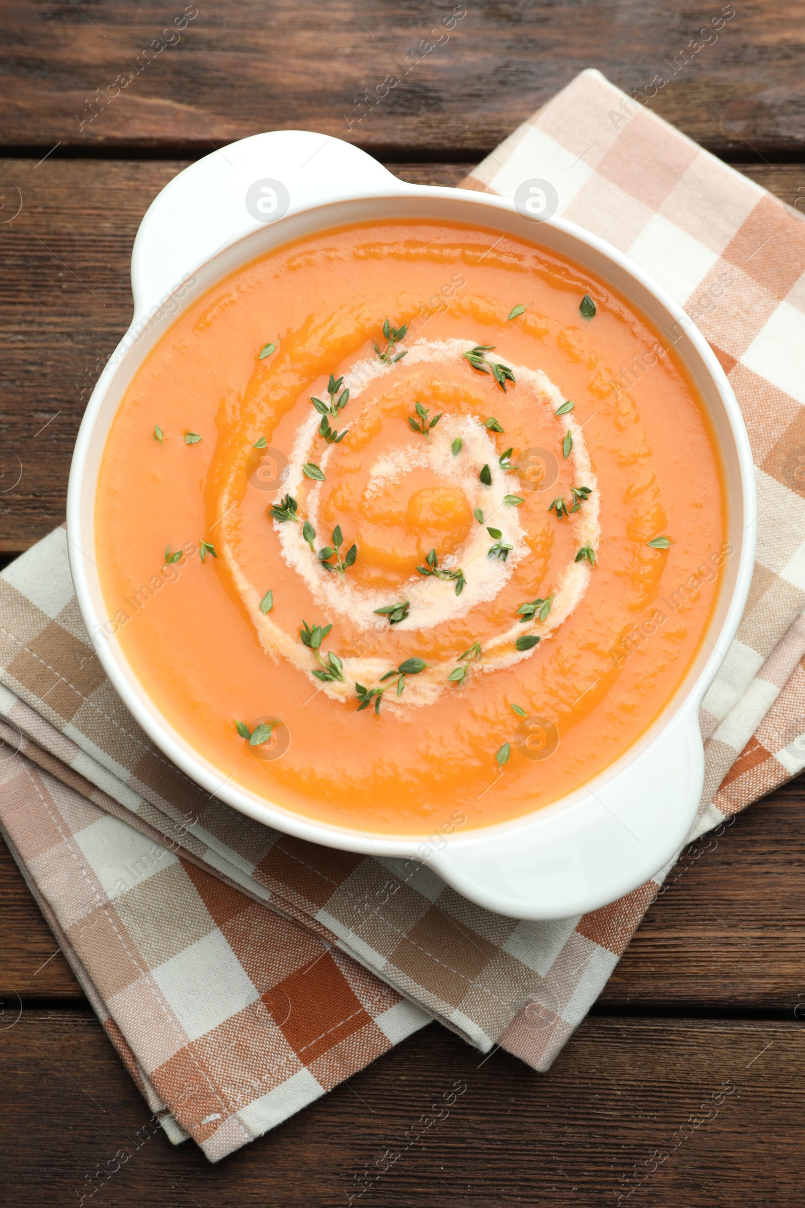 Delicious sweet potato soup with microgreens on wooden table, top view Photo of Delicious sweet potato soup with microgreens on wooden table, top view
