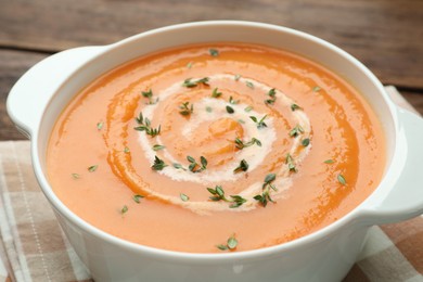 Photo of Delicious sweet potato soup with microgreens on table, closeup