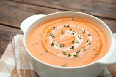 Photo of Delicious sweet potato soup with microgreens on table, closeup