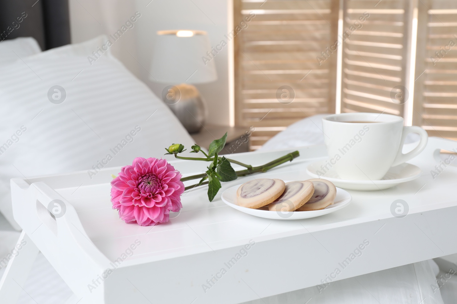 Photo of Breakfast tray on bed with beautiful linens indoors, closeup