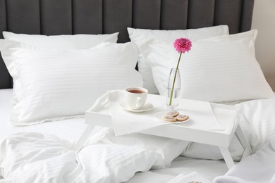 Breakfast tray on bed with beautiful linens indoors