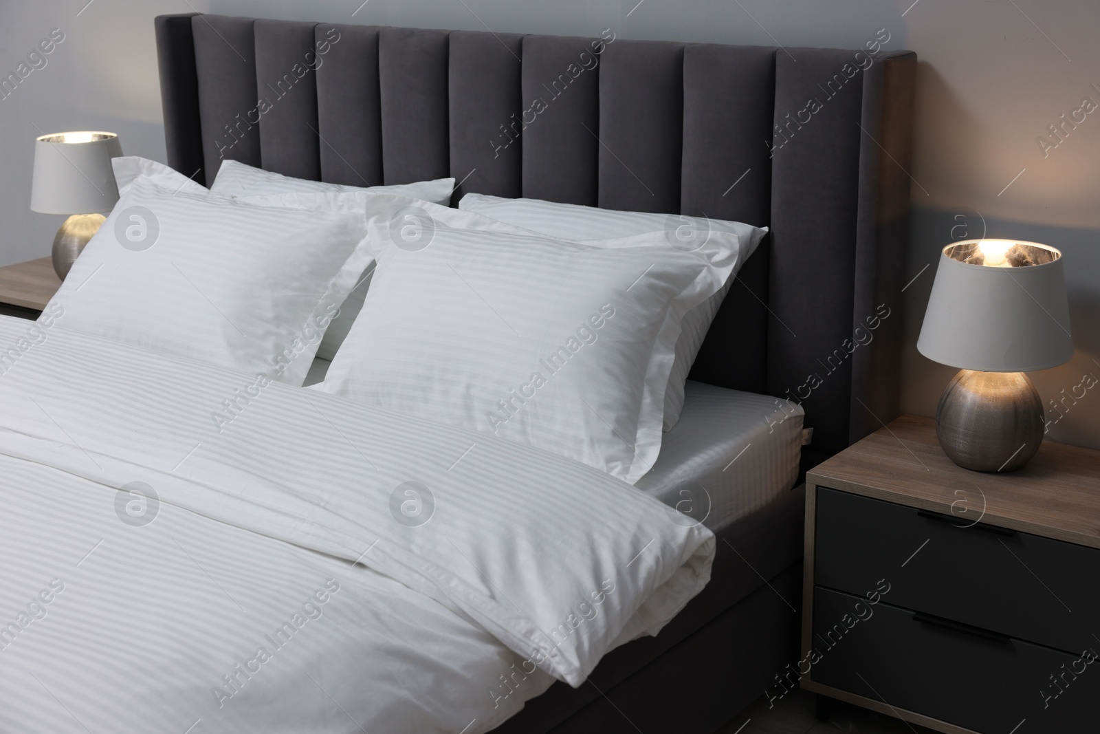 Photo of Bed with clean linens and pillows at home