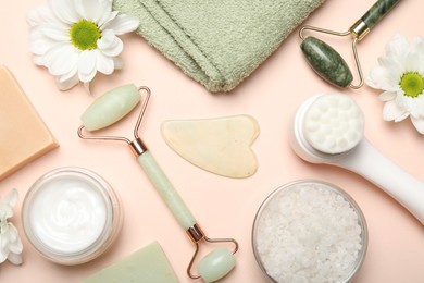 Photo of Flat lay composition with face rollers and gua sha tool on beige background