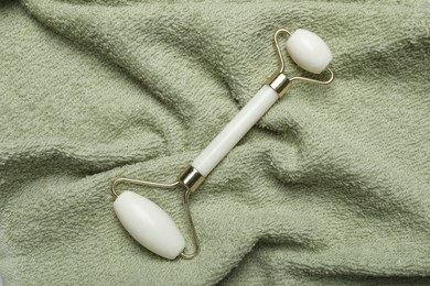 Photo of Face roller on green towel, top view