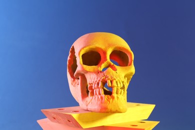 Photo of Human skull and wooden blocks on blue background