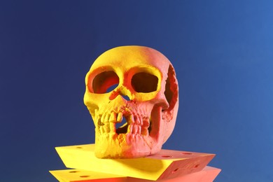 Photo of Human skull and wooden blocks on blue background