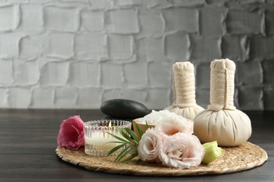 Spa composition with massage bags on wooden table