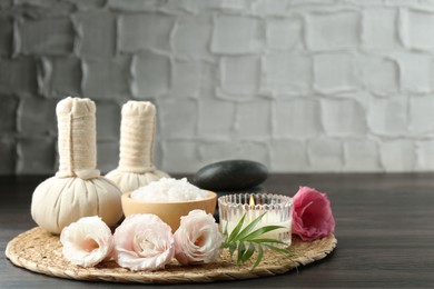 Spa composition with massage bags on wooden table