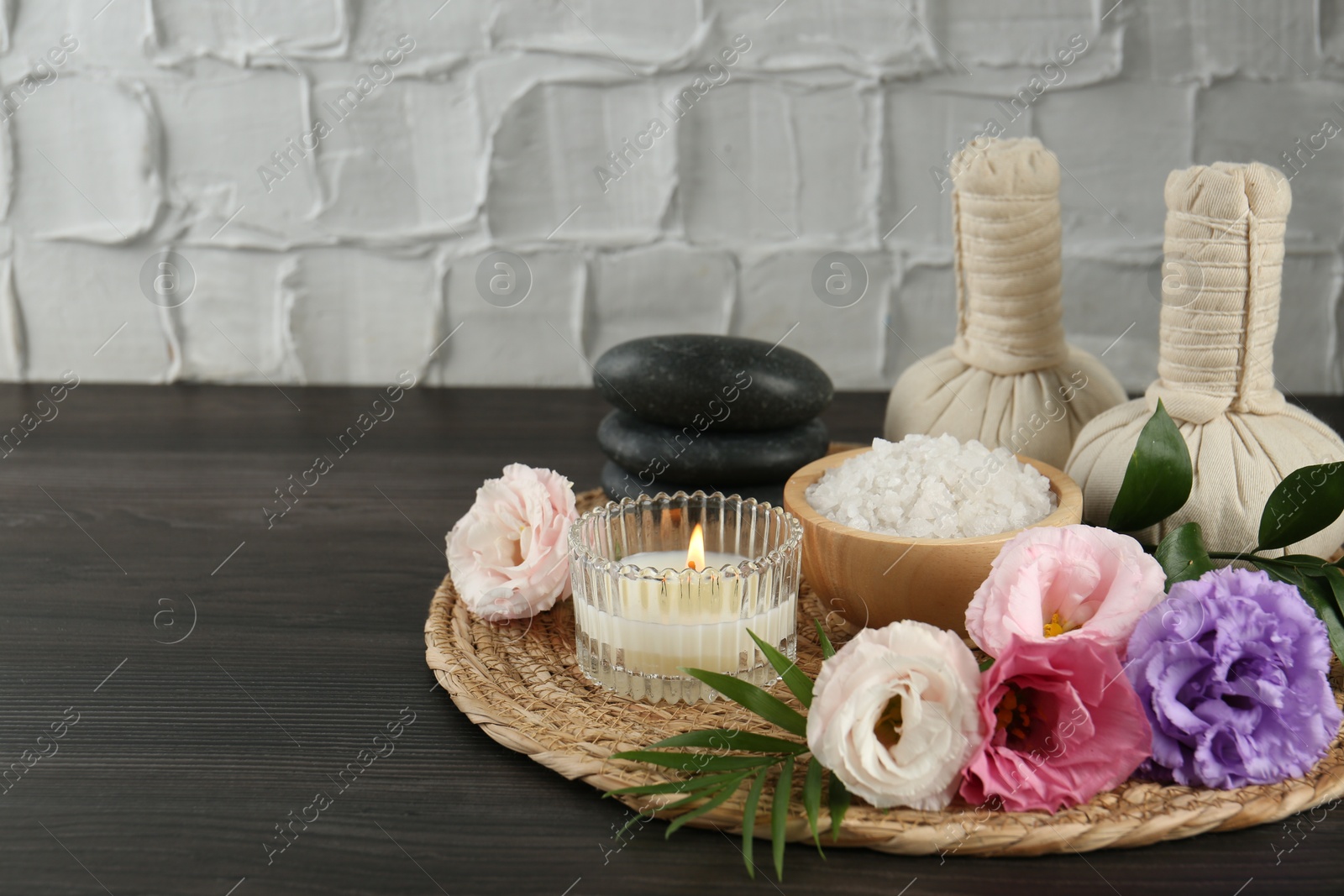 Photo of Spa composition with massage bags on wooden table