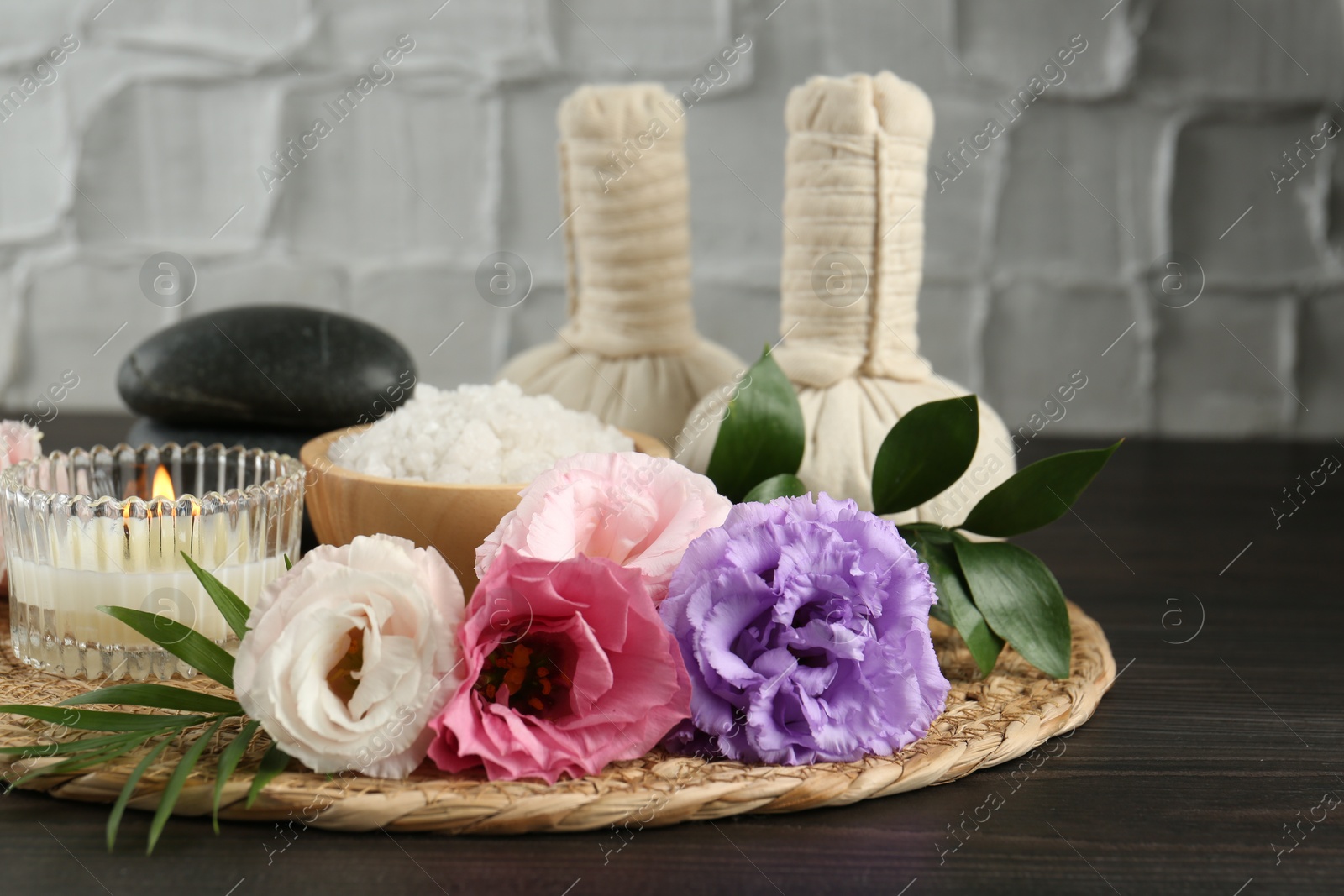 Photo of Spa composition with massage bags on wooden table