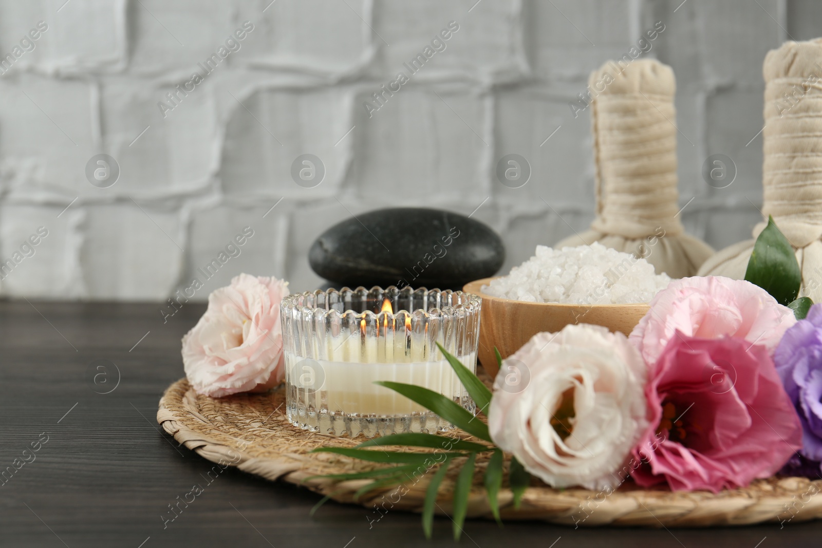 Photo of Spa composition with massage bags on wooden table