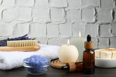 Spa treatment. Composition with cosmetic products and towel on wooden table