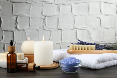 Spa treatment. Composition with cosmetic products and towel on wooden table