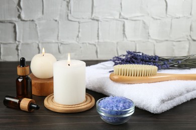 Spa treatment. Composition with cosmetic products and towel on wooden table