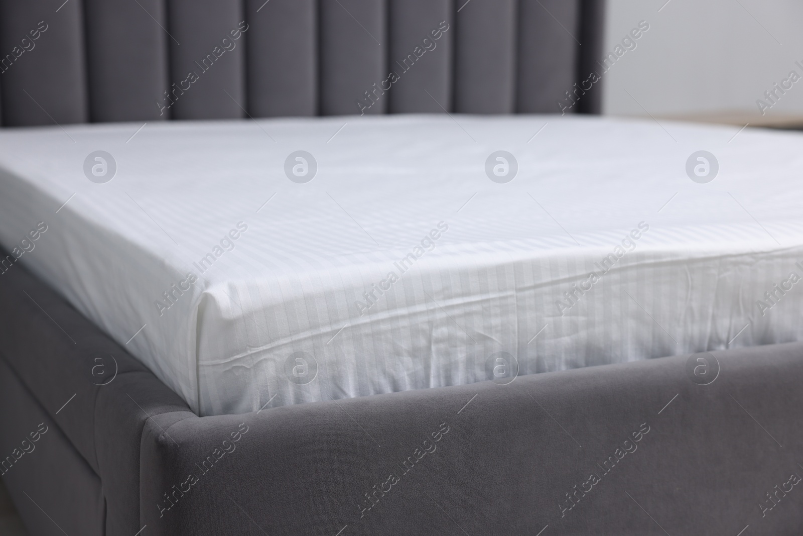 Photo of Comfortable bed with clean linens at home, closeup