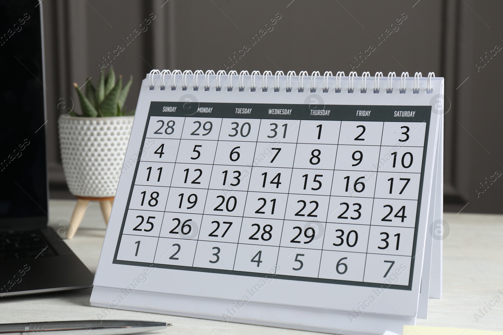 Photo of Timetable. Calendar, pen and laptop on white table