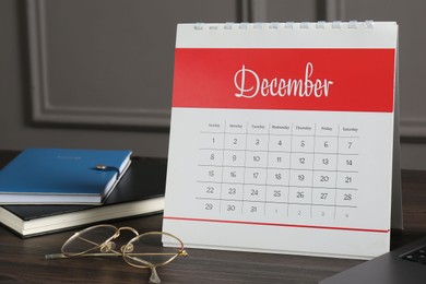 Photo of Timetable. Monthly planner, notebooks and glasses on wooden table