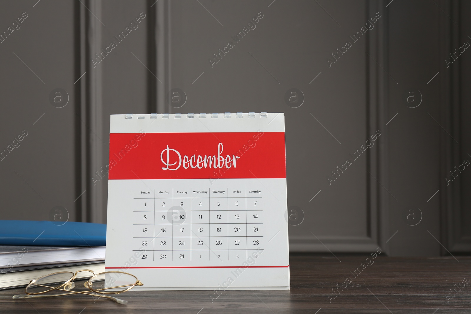 Photo of Timetable. Monthly planner, notebooks and glasses on wooden table