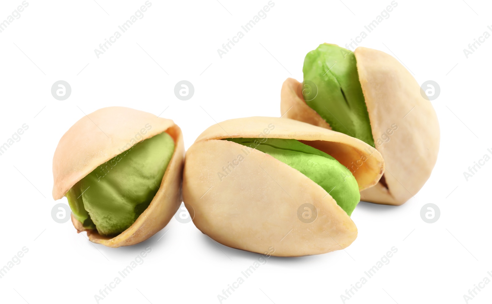 Image of Three tasty pistachio nuts on white background