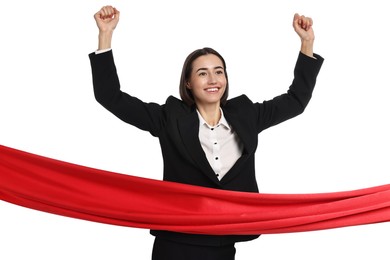 Photo of Young businesswoman in suit crossing red finish line on white background