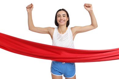 Beautiful woman in sportswear crossing red finish line on white background