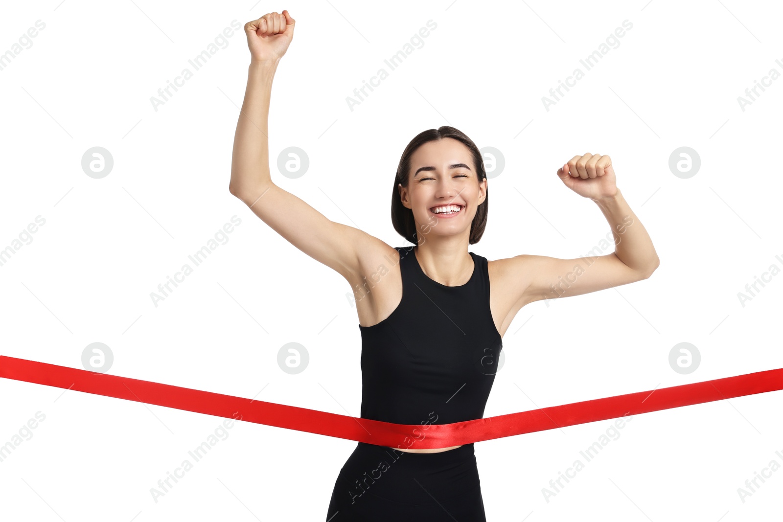 Photo of Beautiful woman in sportswear crossing red finish line on white background