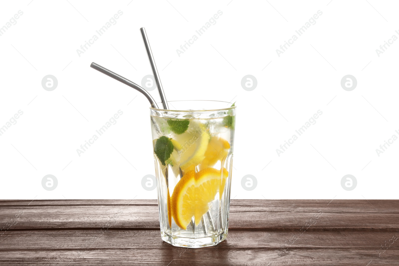 Photo of Glass of tasty refreshing drink and straws on wooden table against white background