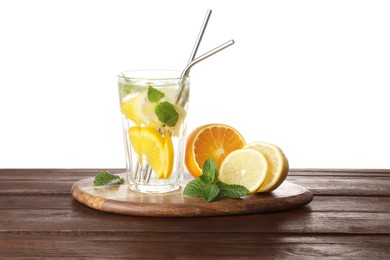 Photo of Glass of tasty refreshing drink with straws and fresh fruits on wooden table against white background