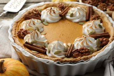 Tasty homemade pumpkin pie in baking dish on table, closeup