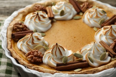 Delicious homemade pumpkin pie in baking dish on table, closeup