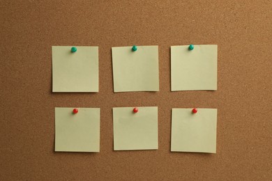 Photo of Beige paper notes pinned to cork board