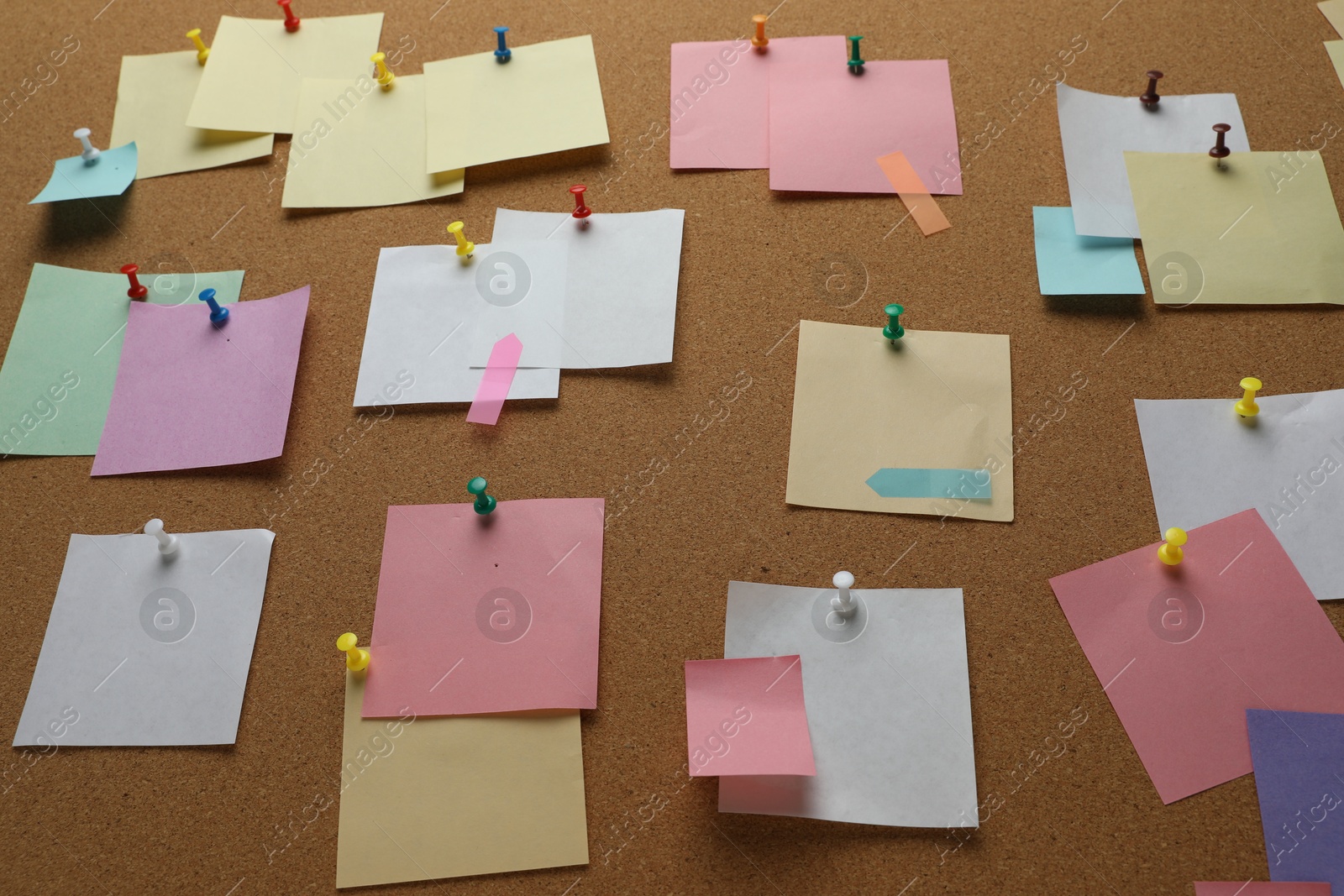 Photo of Colorful paper notes pinned to cork board