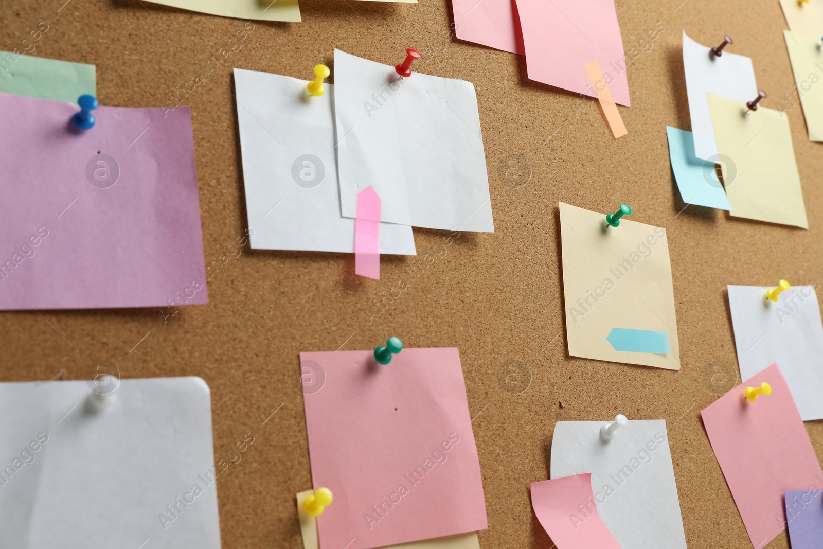 Photo of Colorful paper notes pinned to cork board