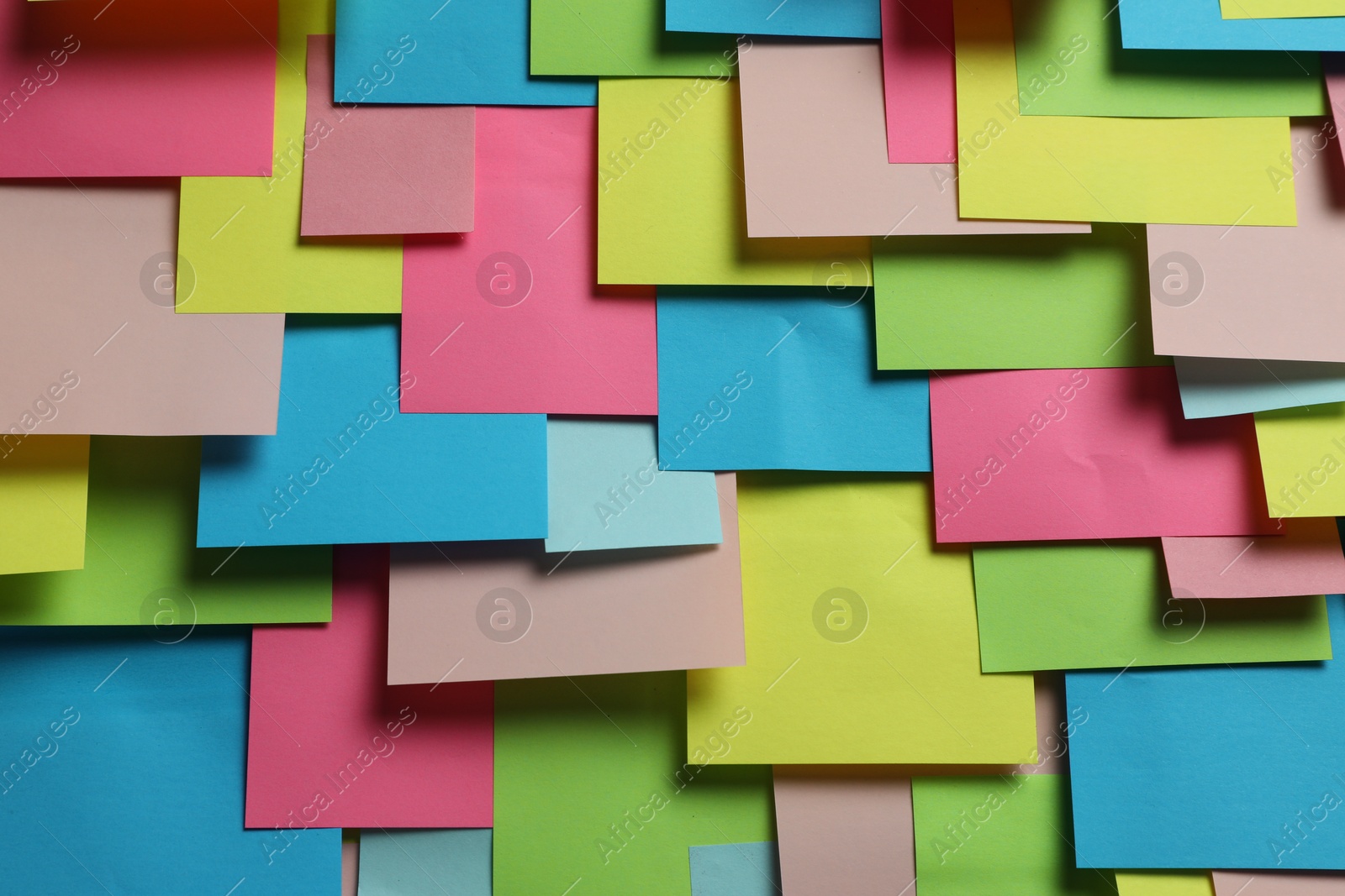 Photo of Colorful paper notes as background, closeup view