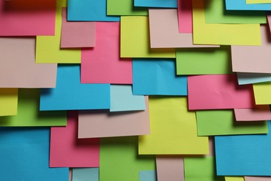 Photo of Colorful paper notes as background, closeup view